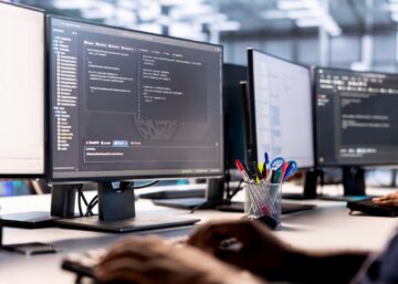 IT professional debugging and optimizing code on server hub in a data center environment